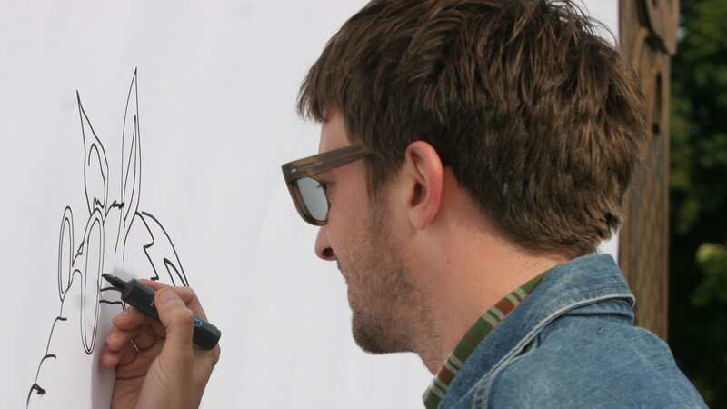 man drawing on whiteboard