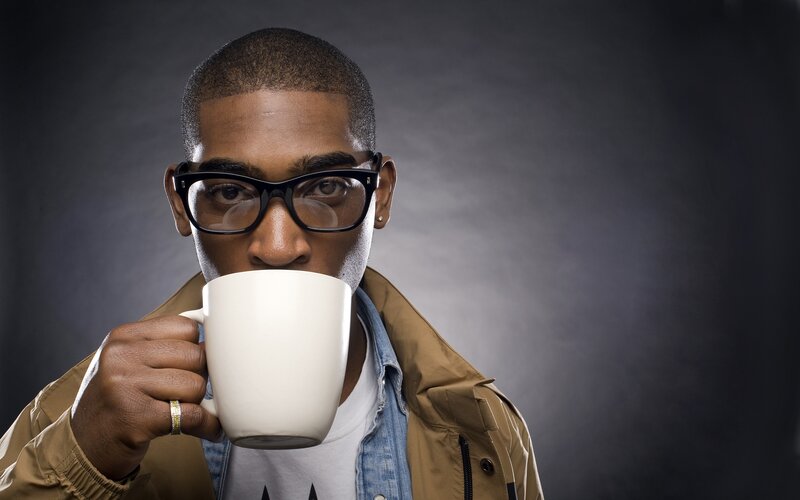 man drinking from a mug