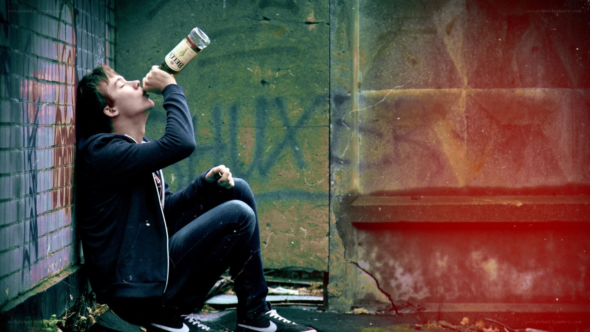 man drinking from bottle