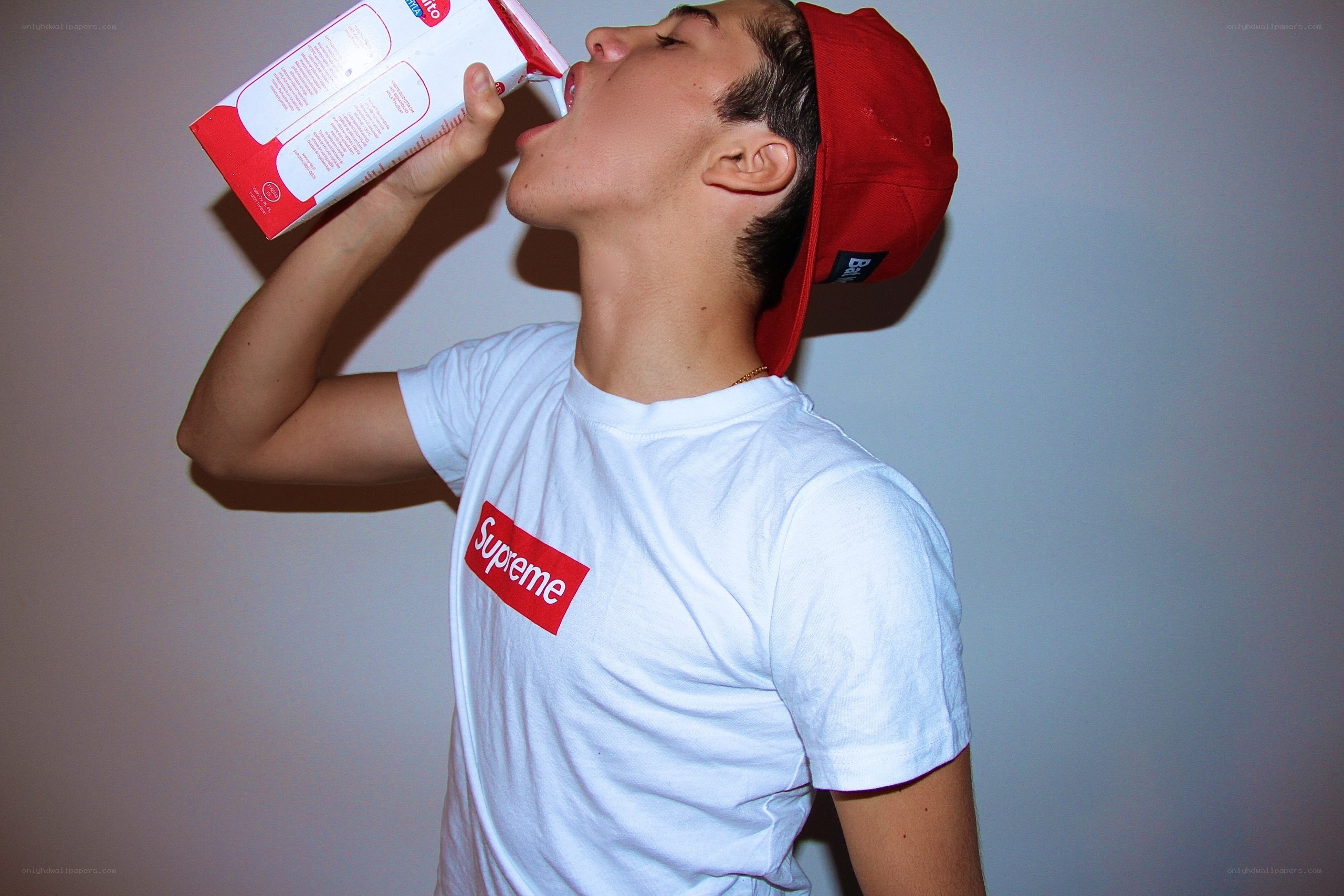 man drinking from carton