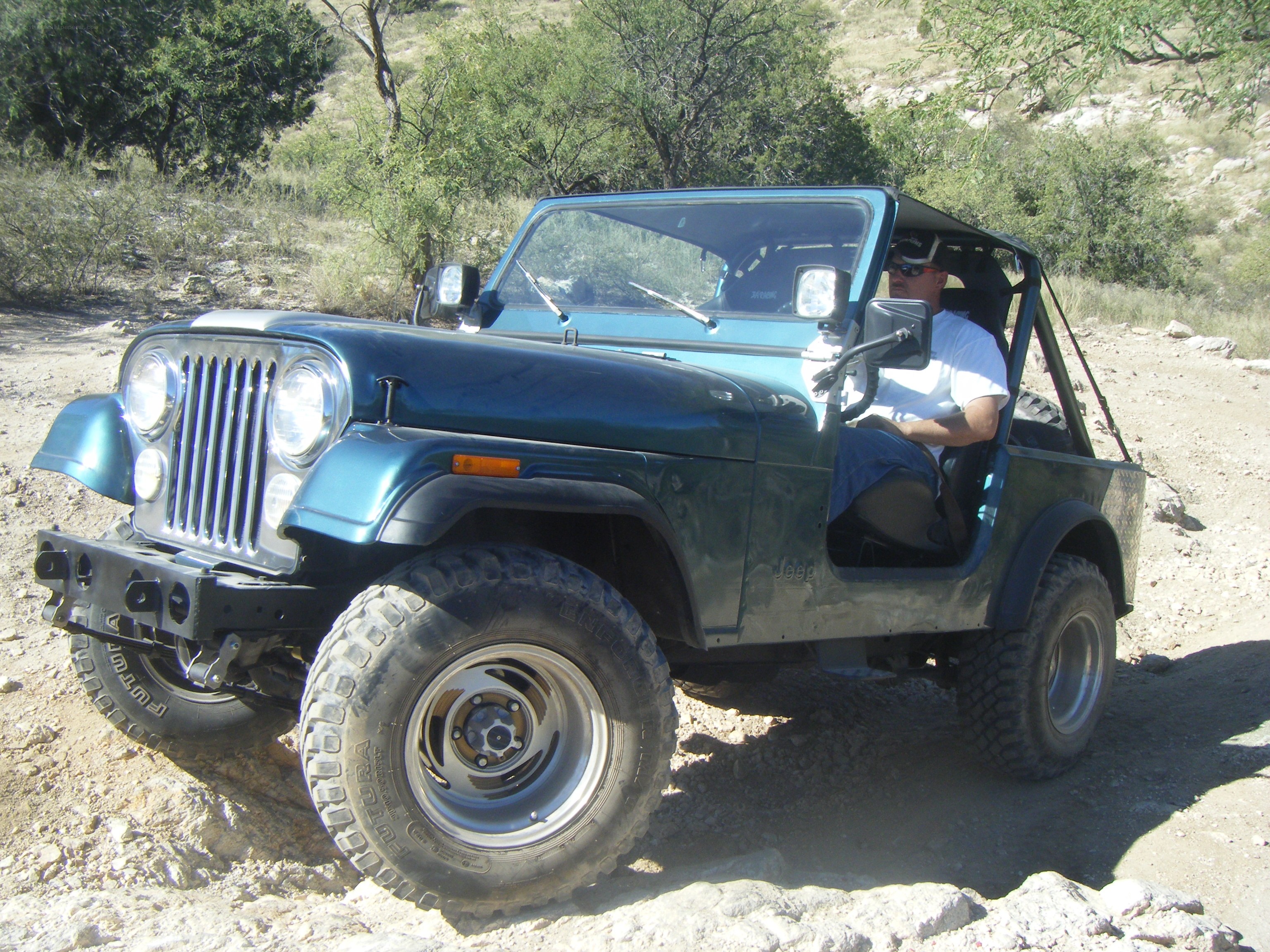 Man driving a Jeep on dirt