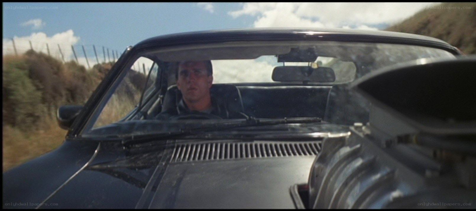 man driving car on road