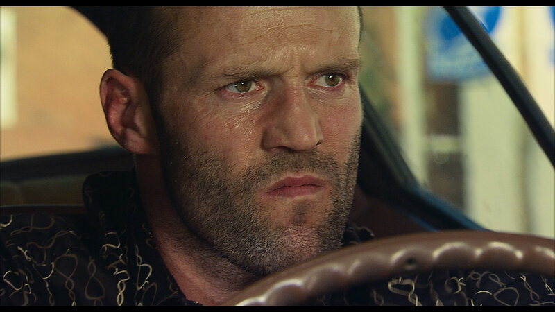 man driving car with intense look