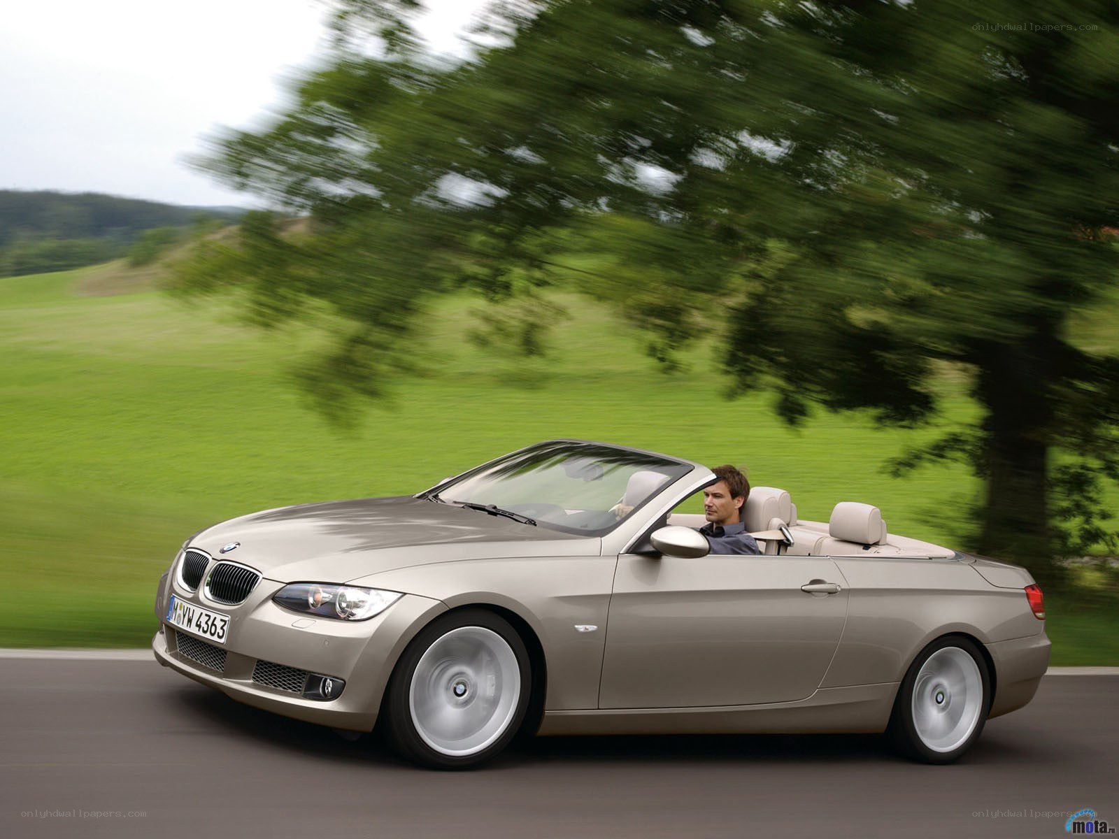 Man driving convertible car