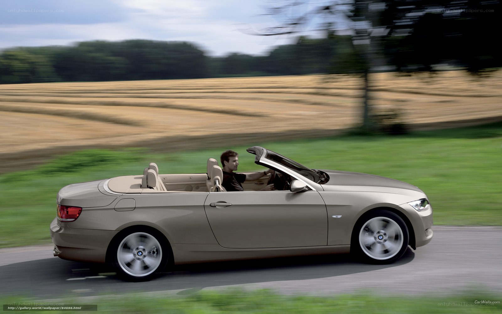 Man driving convertible car