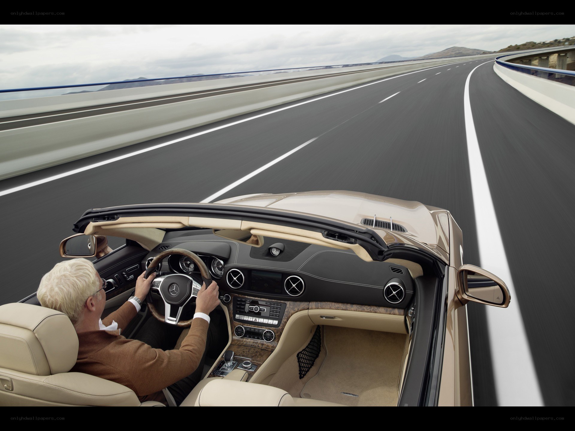 Man driving convertible on highway