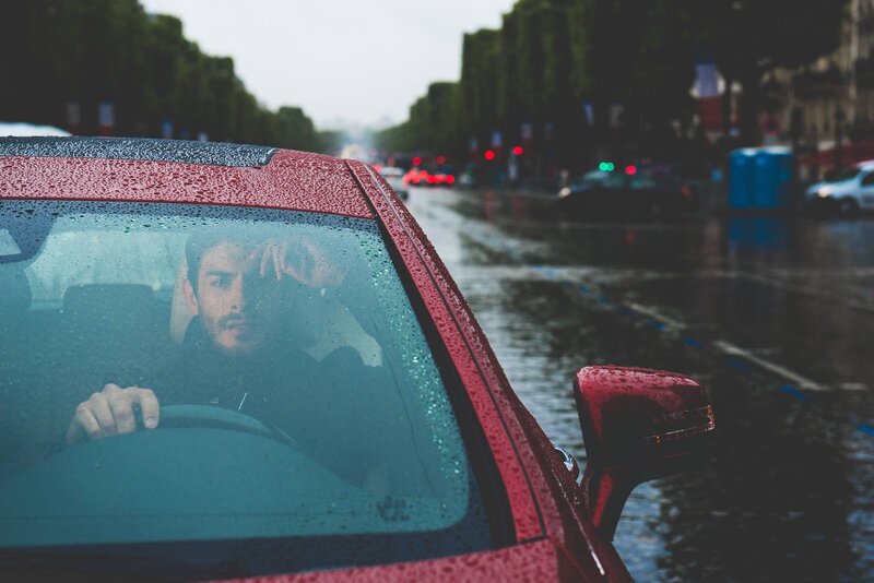 Man Driving in Rain — Red