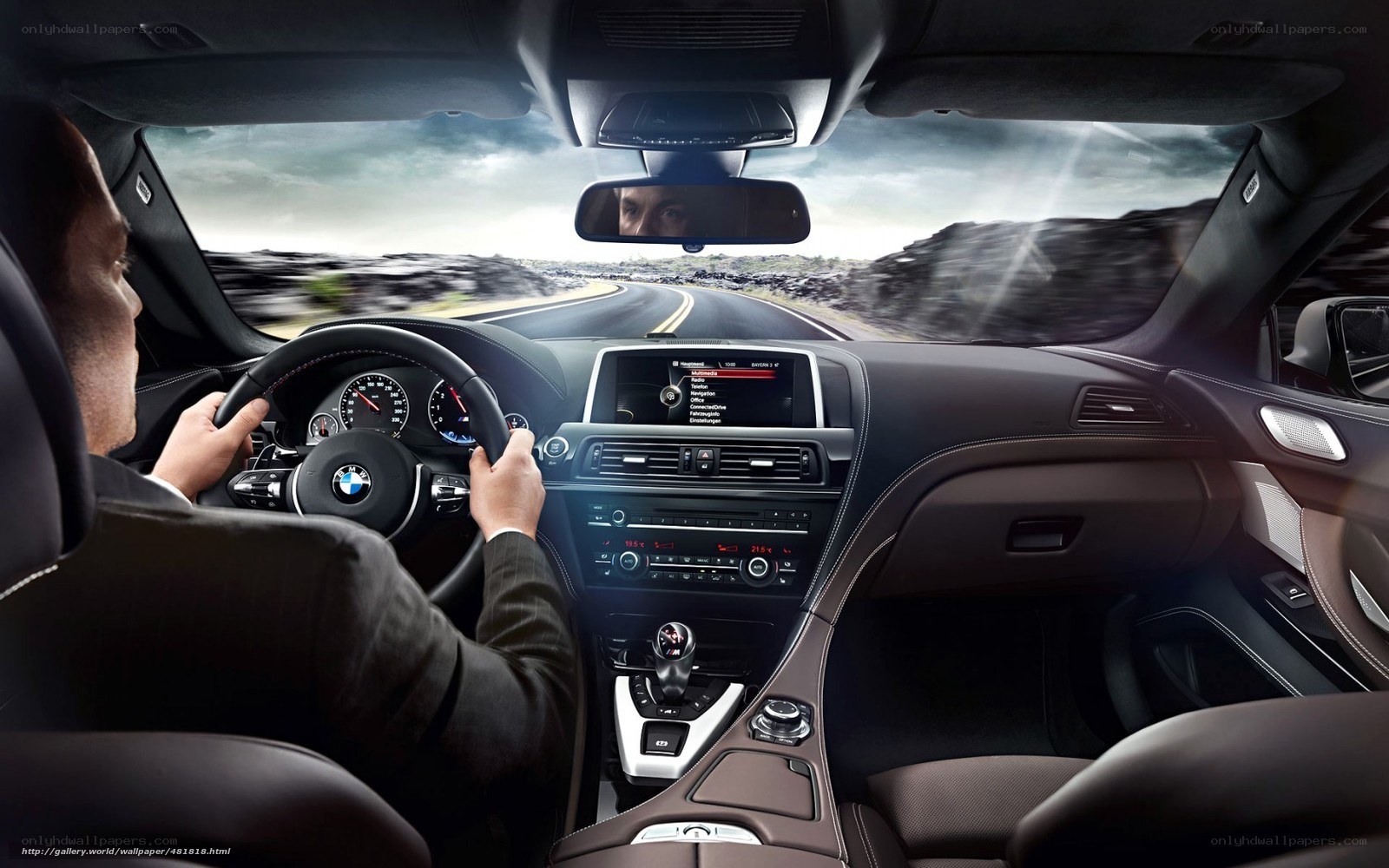 man driving luxury car