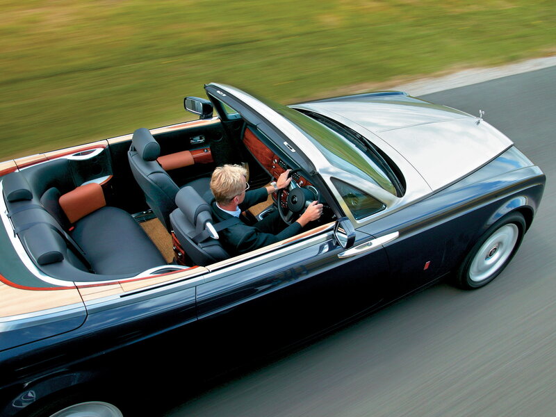 Man driving luxury convertible