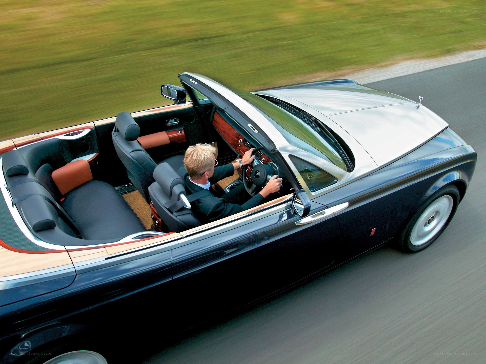 Man driving luxury convertible
