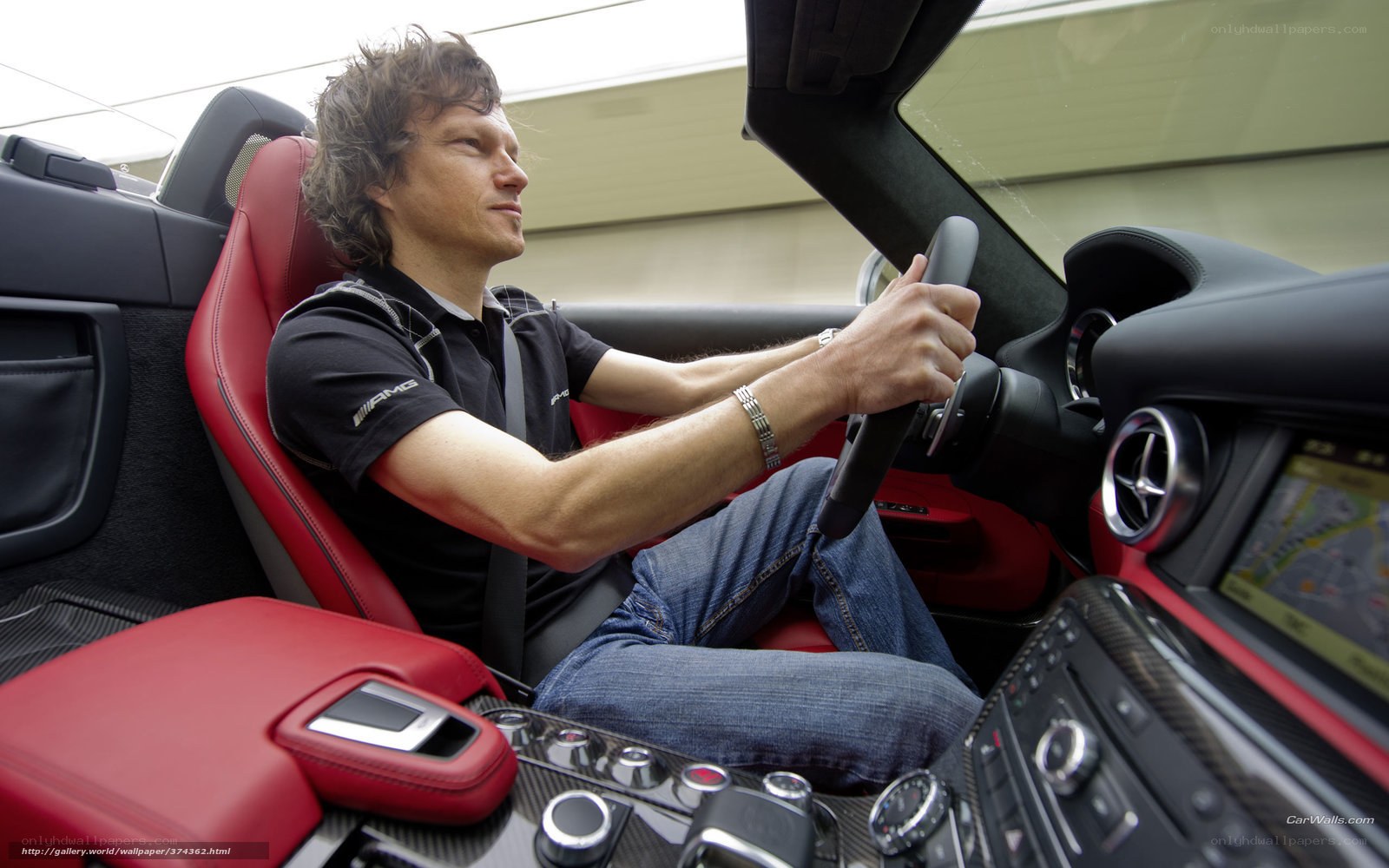 man driving red convertible car