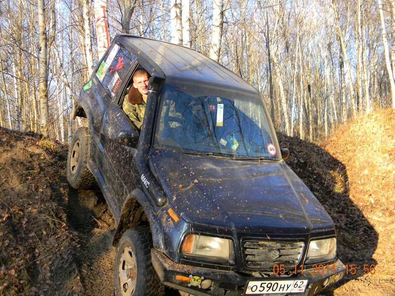 Man driving SUV in forest