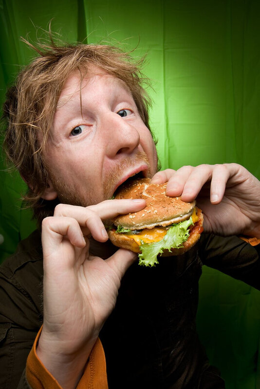man eating a cheeseburger