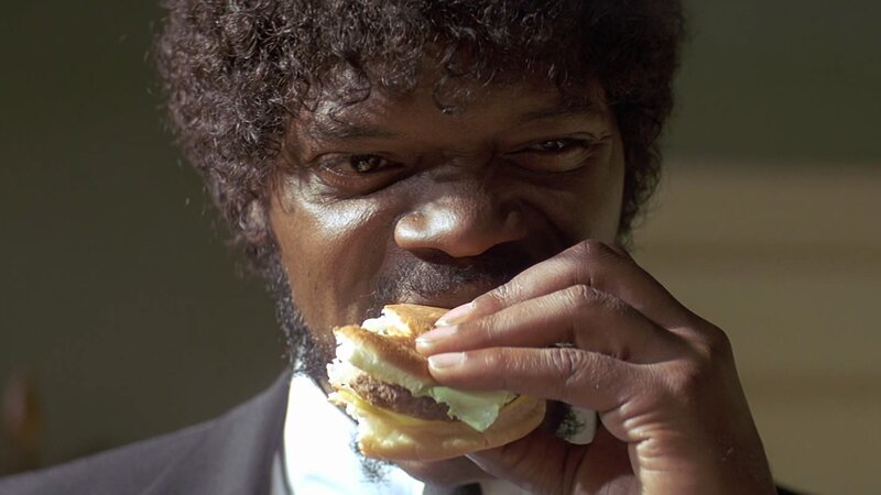 man eating burger in suit