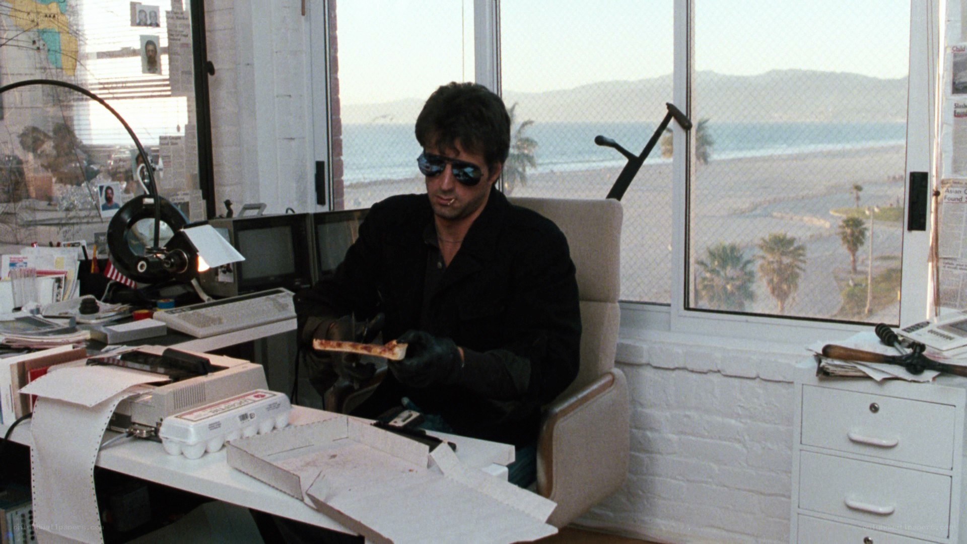 man eating pizza in office