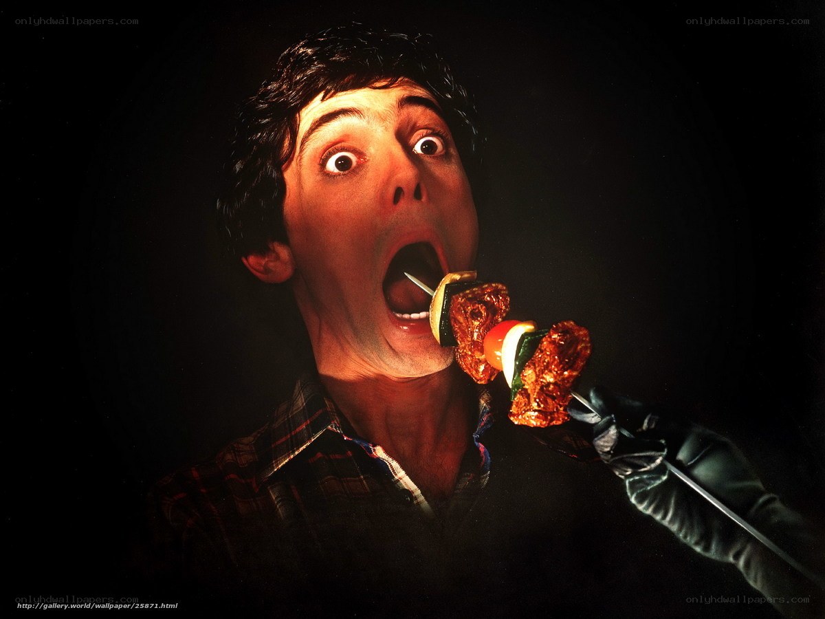 man eating skewer with shocked expression