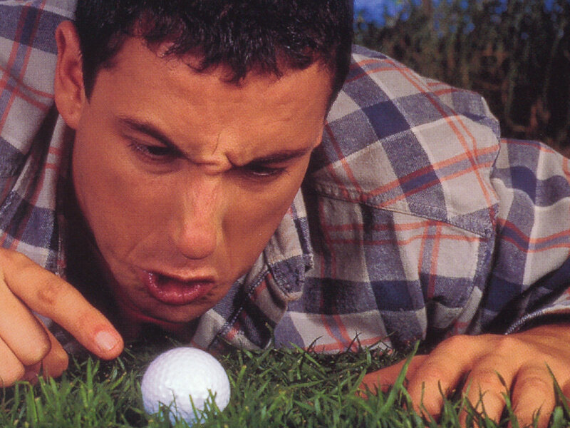man examining golf ball