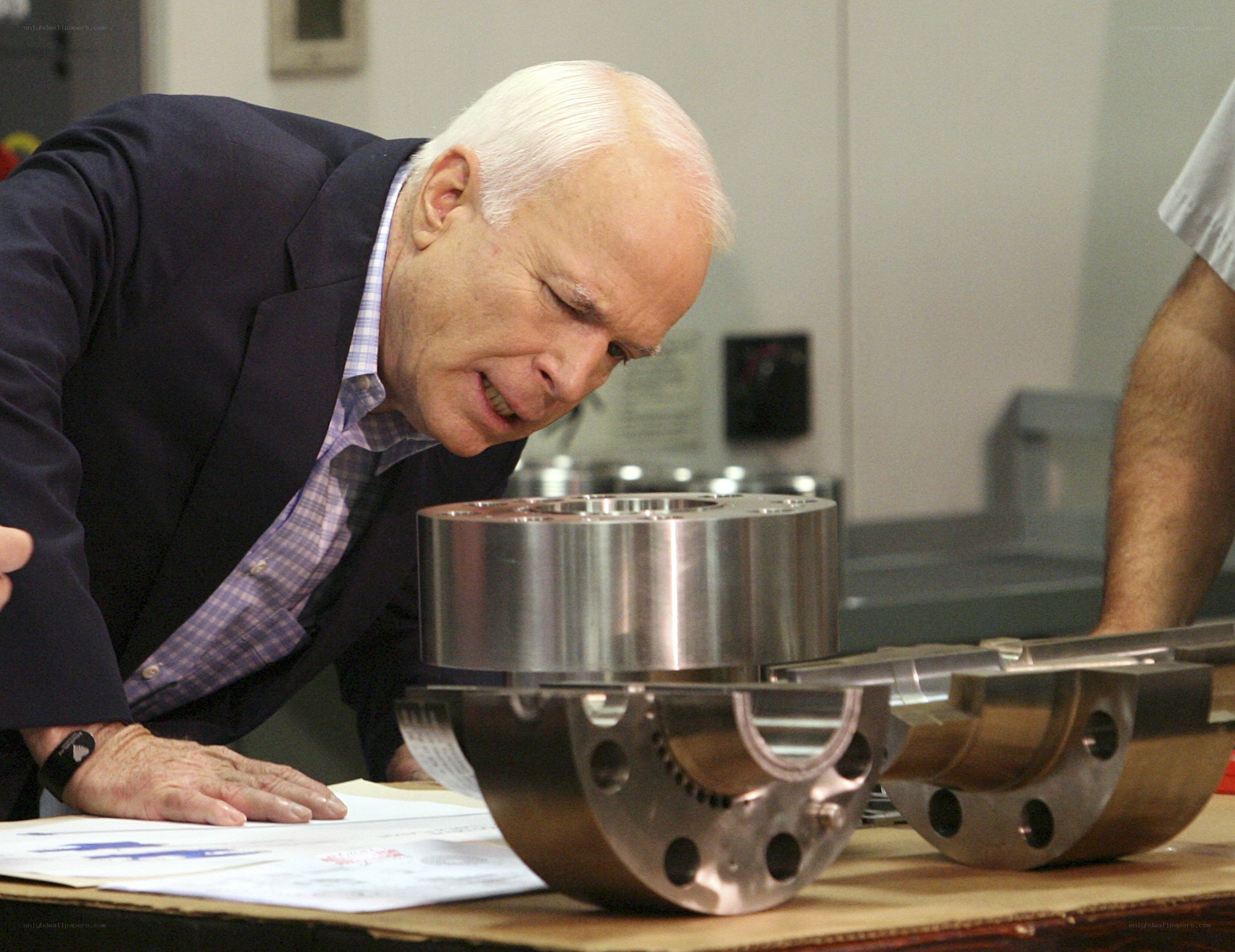 man examining metal parts