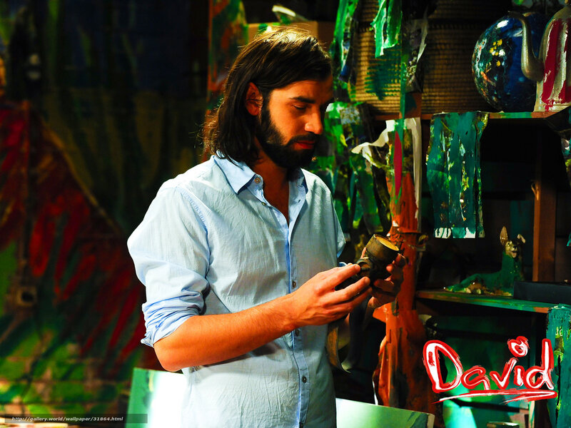man examining pottery in studio