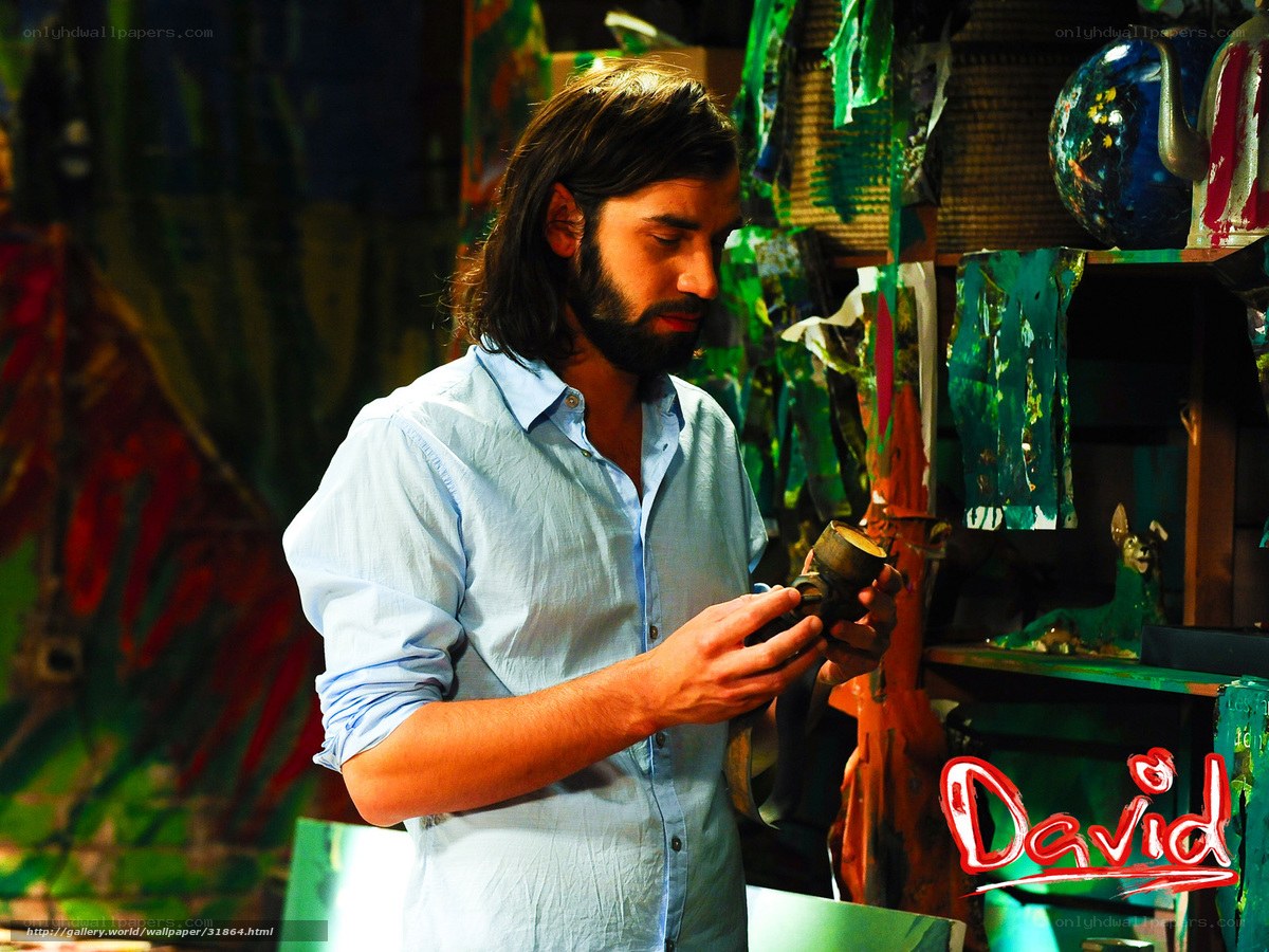 man examining pottery in studio