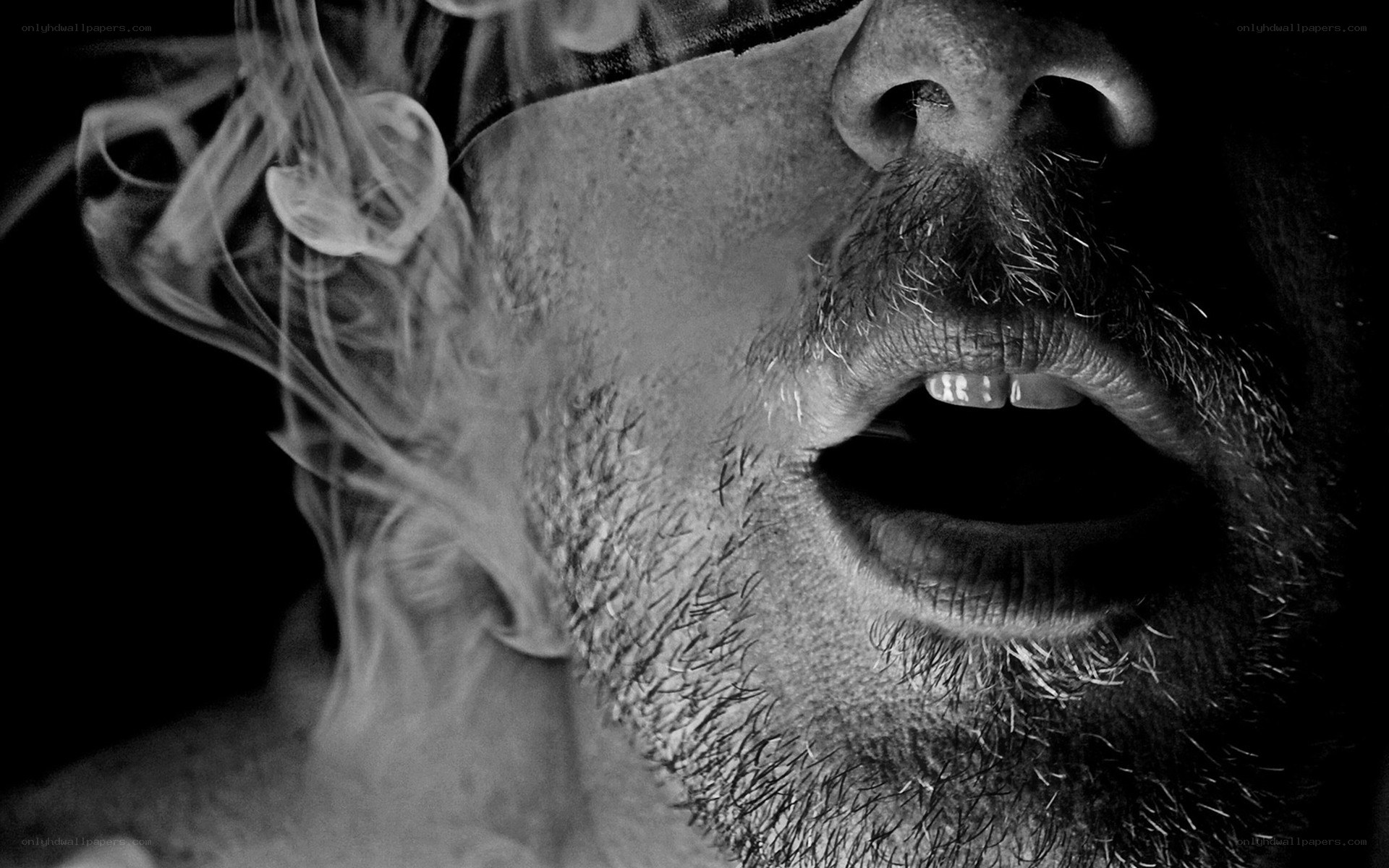man exhaling smoke
