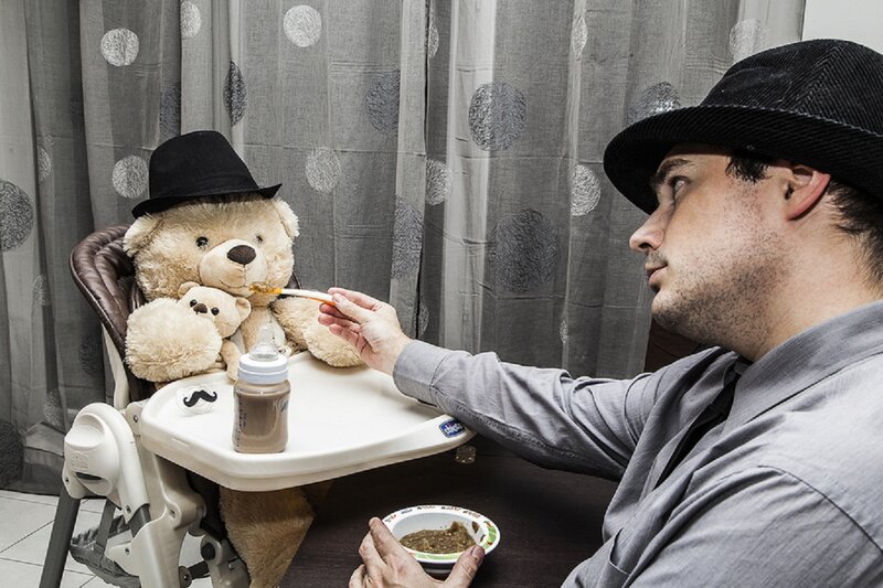 Man Feeding Teddy Bear