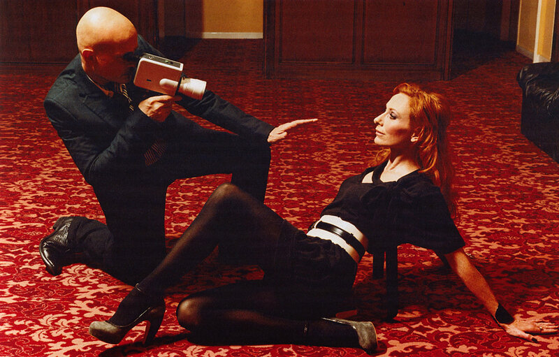 Man filming woman on floor