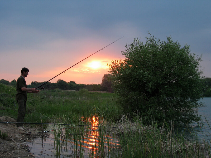 Man Fishing at Sunset — Orange