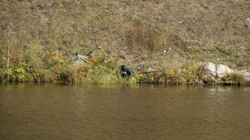 Man fishing by a river