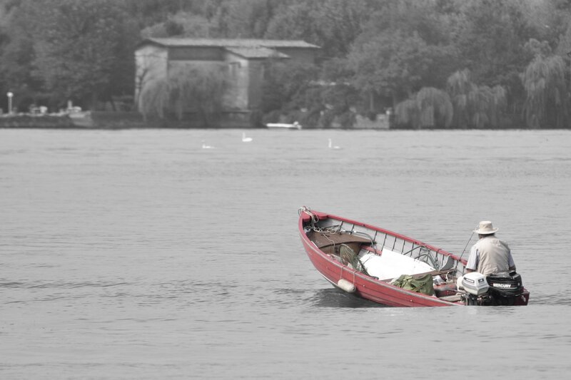Man fishing in a red boat