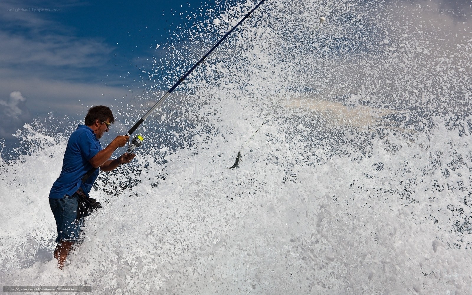 Man fishing in ocean waves