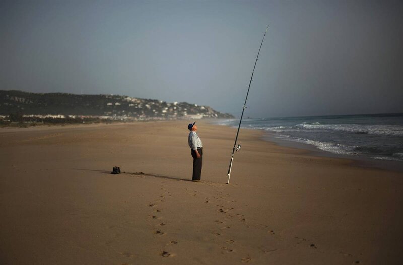 Man fishing on a quiet beach