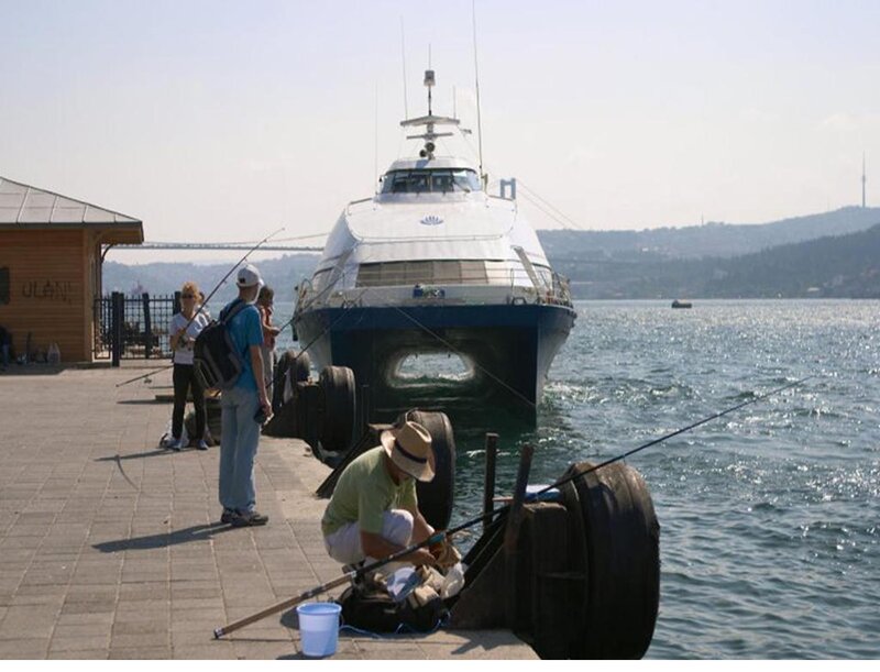 Man Fishing on Pier — Blue