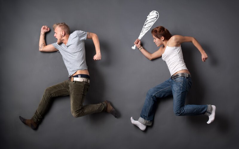 Man fleeing woman with bat