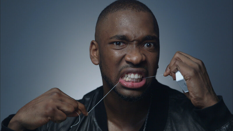man flossing teeth