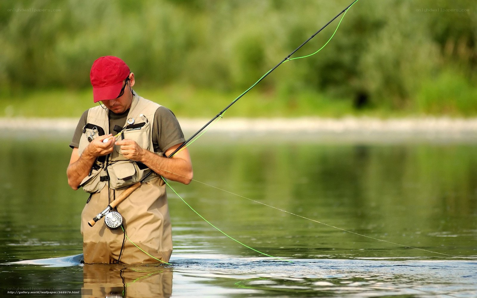 man fly fishing in river