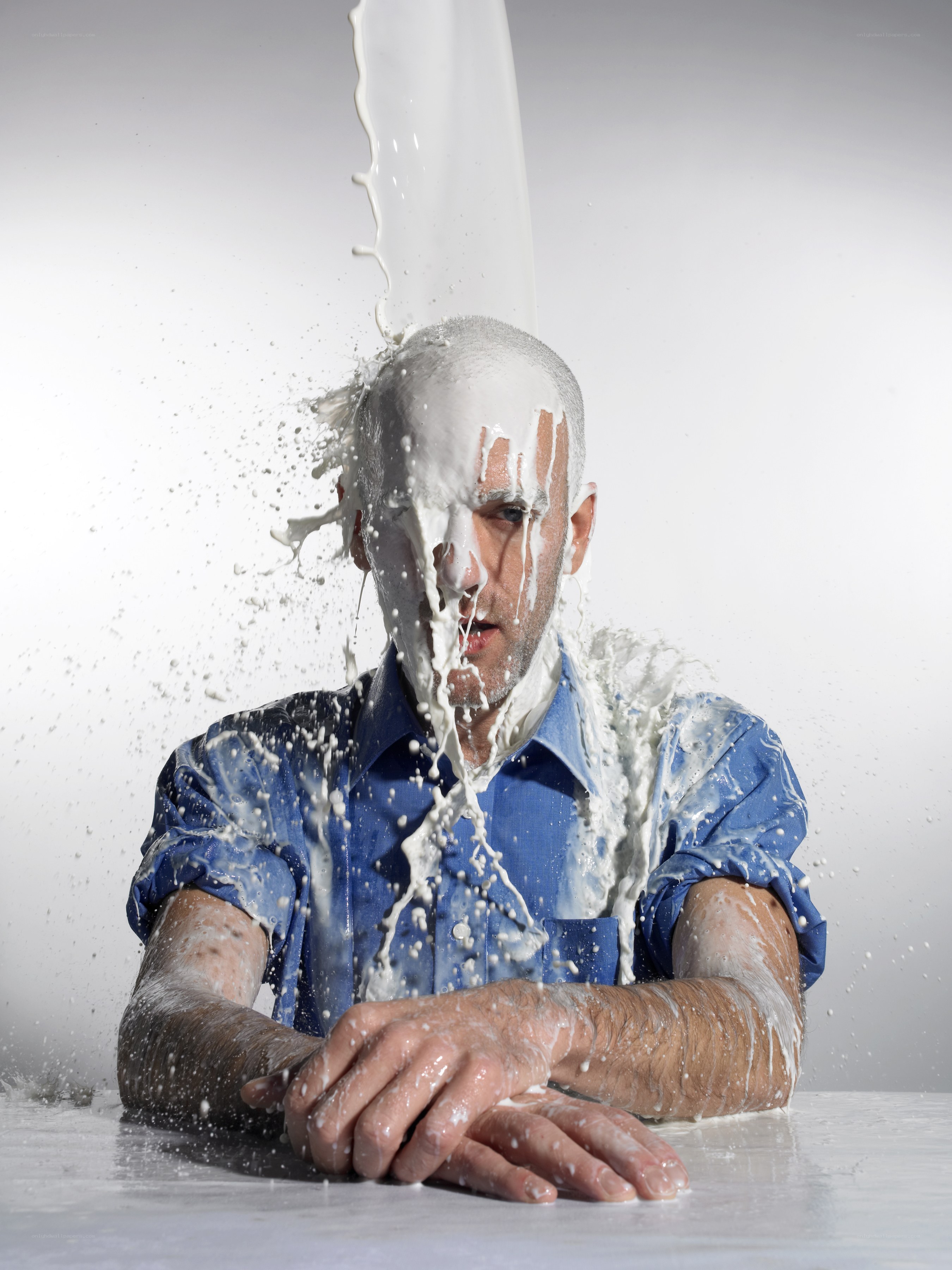 man getting poured on with milk