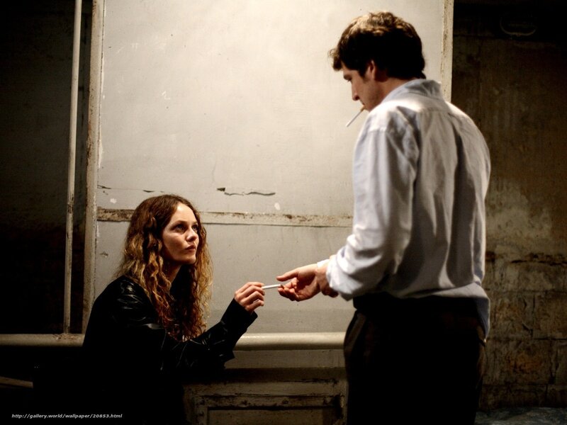 Man giving cigarette to woman