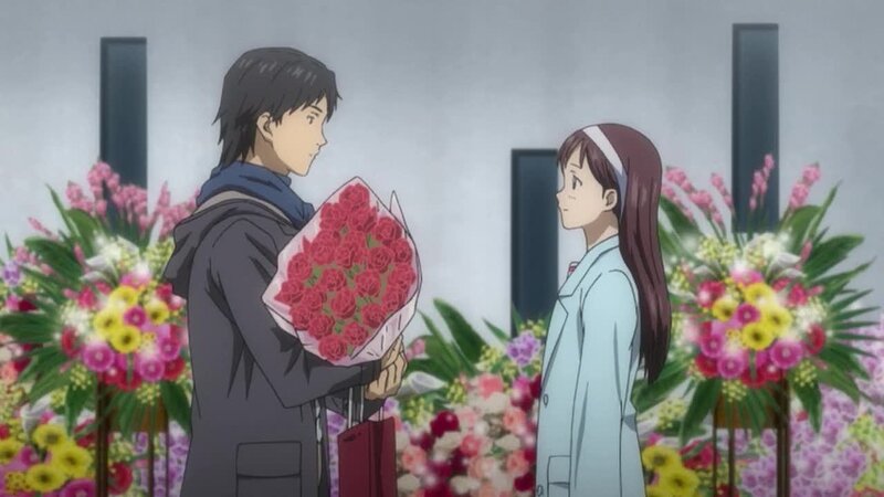 man giving flowers to woman
