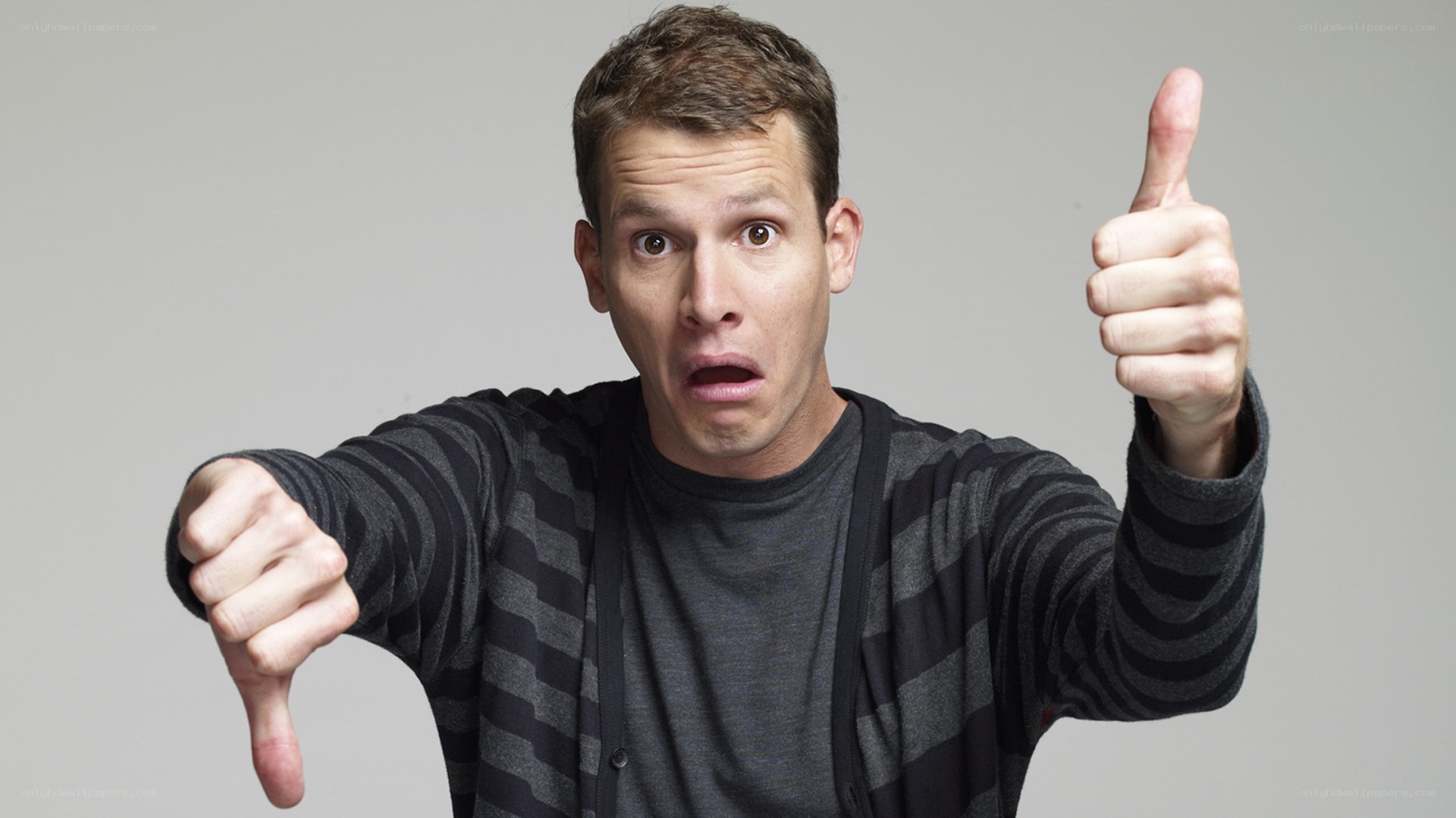 man giving thumbs up and down