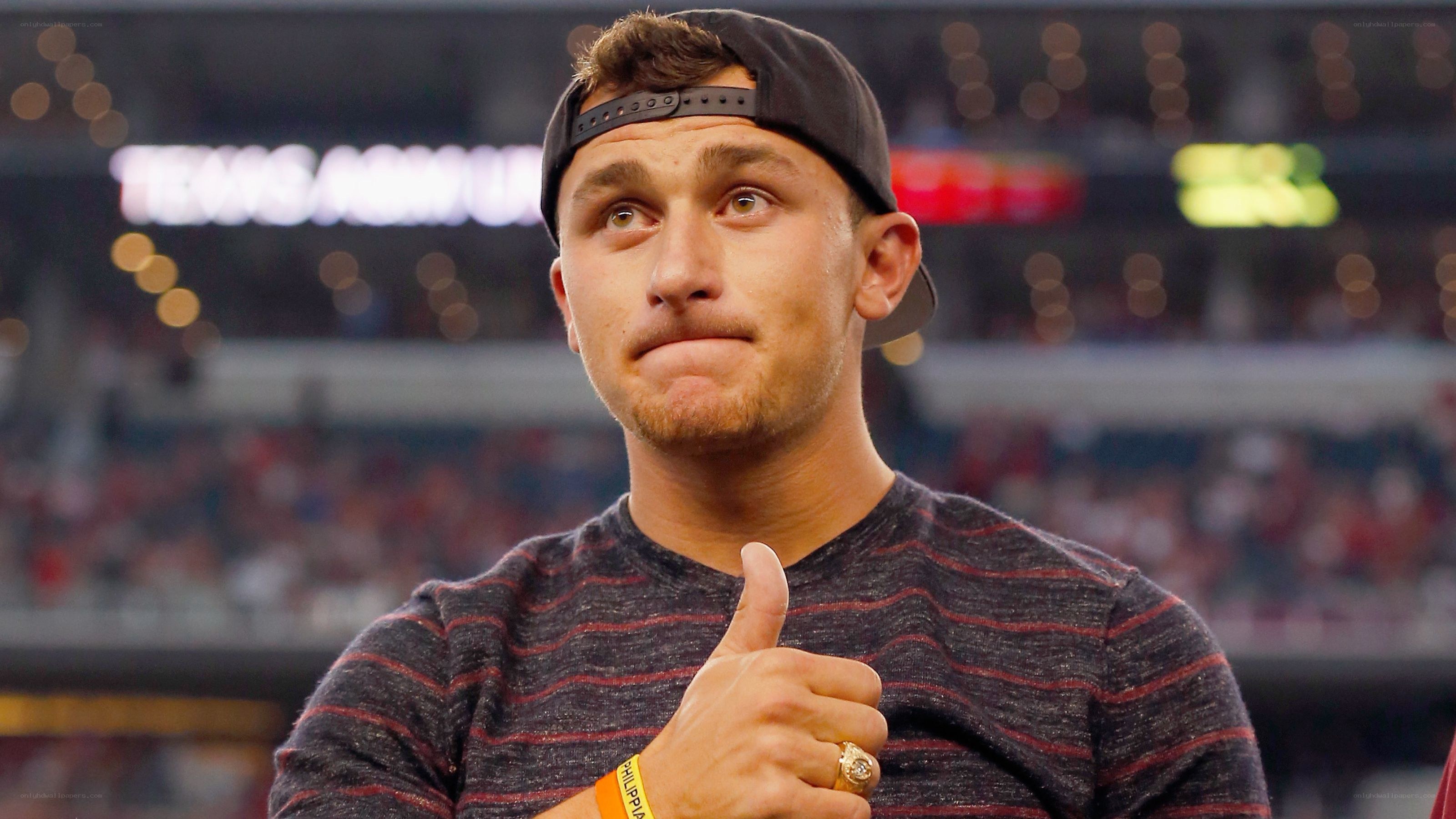 man giving thumbs up at stadium