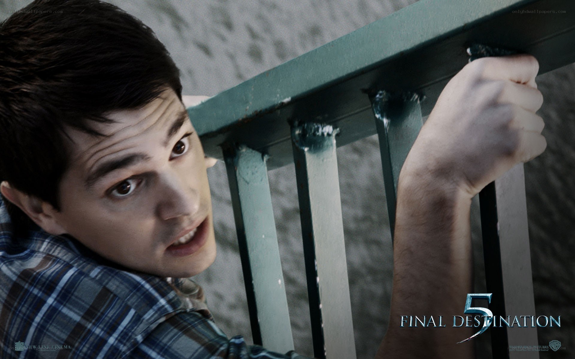 man gripping railing in suspense
