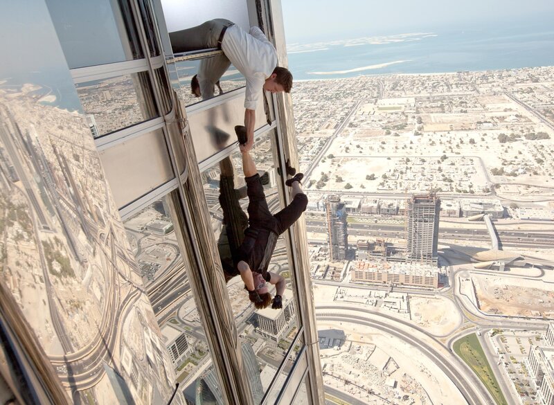 Man Hanging from Skyscraper