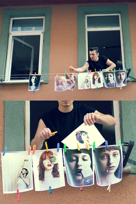 man hanging photos on a line