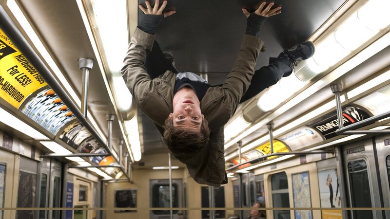 Man hanging upside down in subway
