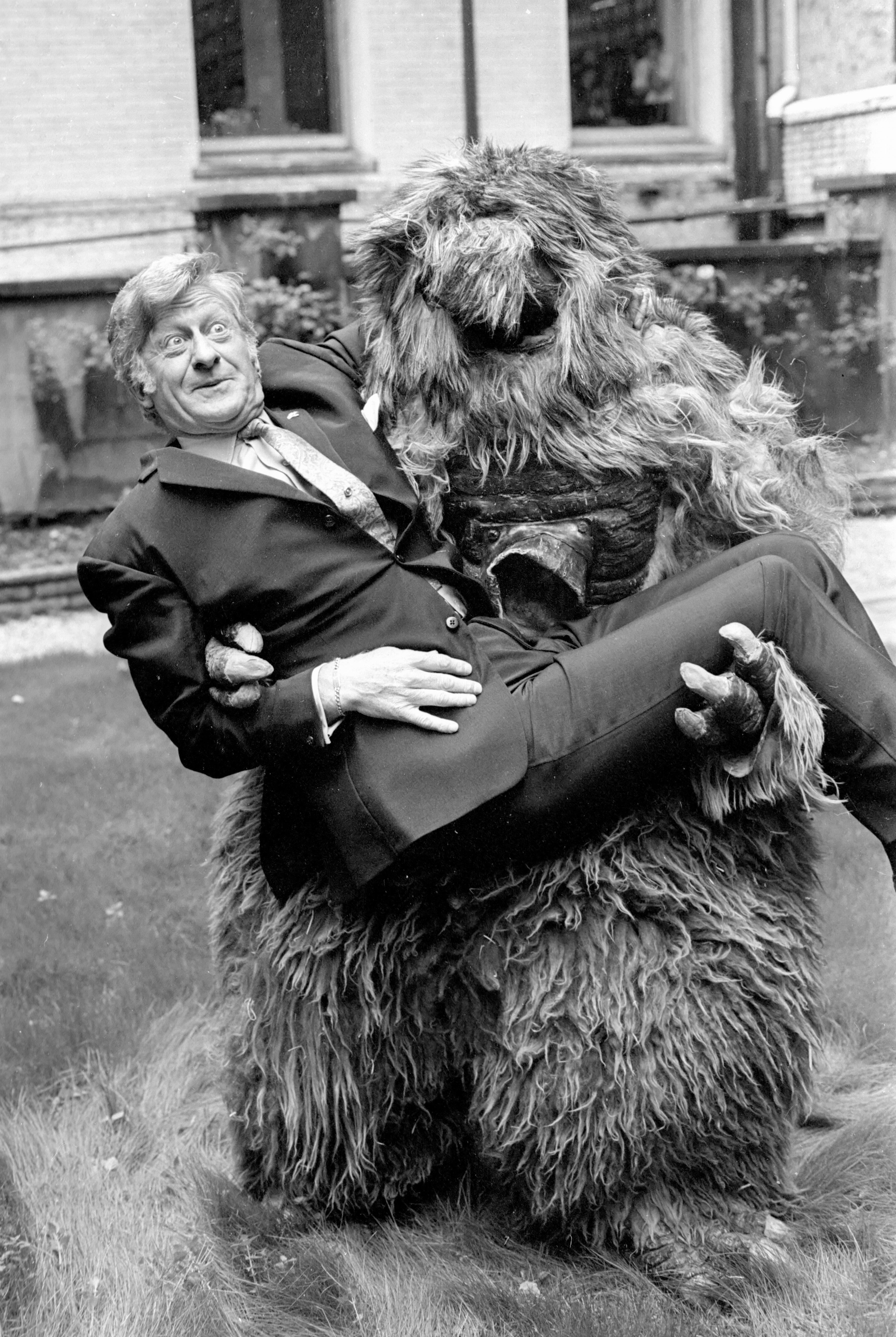 Man held by furry creature