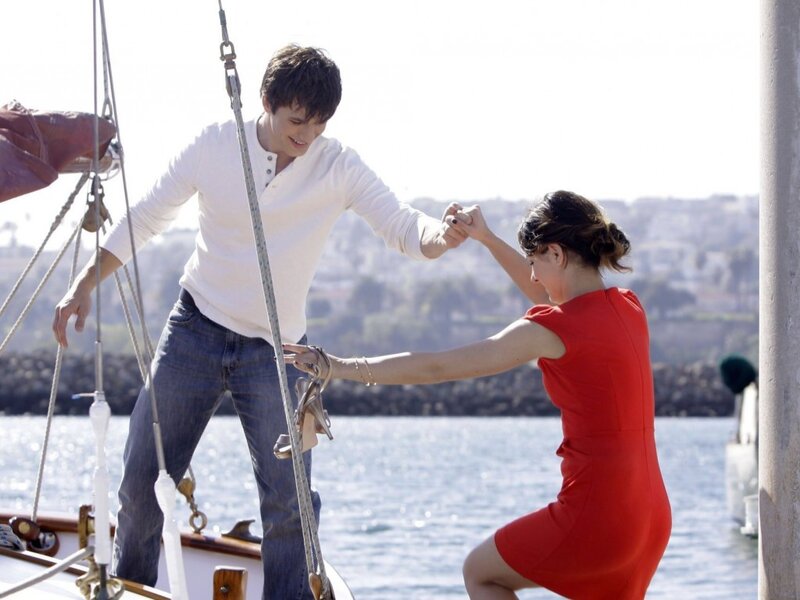 Man Helping Woman on Boat