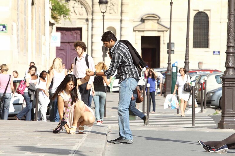 Man helping woman on street