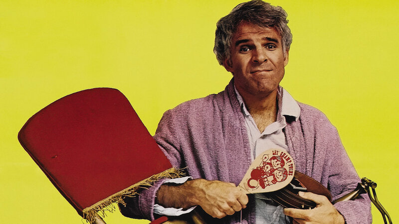 Man holding a fan and chair