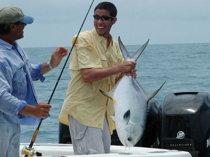 Man holding a fish on a boat